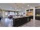 Spacious open-concept kitchen featuring a large island, stainless appliances and dark cabinets at 7998 W Ford Ave, Las Vegas, NV 89113