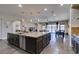 Open kitchen with a large granite island, stainless appliances, and seamless flow to the living spaces and patio at 7998 W Ford Ave, Las Vegas, NV 89113