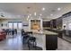 Open concept kitchen with large island and seating flows seamlessly into the dining and living areas at 7998 W Ford Ave, Las Vegas, NV 89113