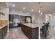 Spacious kitchen boasts dark cabinetry, granite counters, stainless steel appliances, and a large center island at 7998 W Ford Ave, Las Vegas, NV 89113