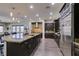 Gourmet kitchen with a huge island, stainless steel appliances and dark cabinets at 7998 W Ford Ave, Las Vegas, NV 89113