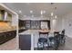 Gourmet kitchen features a large island, granite countertops, stainless steel appliances, and dark wood cabinets at 7998 W Ford Ave, Las Vegas, NV 89113