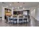 Expansive kitchen showcasing a large island with seating, dark cabinets, and state-of-the-art stainless steel appliances at 7998 W Ford Ave, Las Vegas, NV 89113