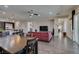 Open-concept living and dining area with hardwood floors and access to kitchen, dining, and hallway at 7998 W Ford Ave, Las Vegas, NV 89113