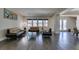 A sophisticated living room offers stylish leather sofas, sleek flooring, and ample natural light through large windows at 7998 W Ford Ave, Las Vegas, NV 89113