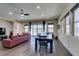 Bright living room and dining area with hardwood floors and sliding door access to the backyard at 7998 W Ford Ave, Las Vegas, NV 89113