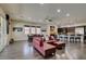 Open floor plan with living room, kitchen, dining, and hardwood floors bathed in natural light at 7998 W Ford Ave, Las Vegas, NV 89113