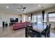 Open-concept living room and dining room features hardwood floors and access to the pool and backyard at 7998 W Ford Ave, Las Vegas, NV 89113