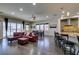 Open concept living space with kitchen, dining area, bar seating and access to backyard and pool at 7998 W Ford Ave, Las Vegas, NV 89113