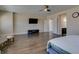 Large main bedroom featuring hardwood floors, a ceiling fan, and a wall-mounted television at 7998 W Ford Ave, Las Vegas, NV 89113