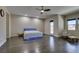 Bright main bedroom with hardwood floors, recessed lights and an adjacent sitting area with chairs at 7998 W Ford Ave, Las Vegas, NV 89113