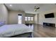 Spacious main bedroom with ceiling fan, wall-mounted TV, and access to the outside patio at 7998 W Ford Ave, Las Vegas, NV 89113