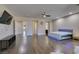 A full view of the spacious main bedroom, with hardwood floors, television and access to the main bathroom at 7998 W Ford Ave, Las Vegas, NV 89113