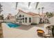 Backyard with a large pool and deck area surrounded by lush landscaping and patio furniture at 8104 Bay Harbor Dr, Las Vegas, NV 89128
