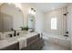 Charming bathroom featuring double sinks, a tub, and striped wall tiles at 8104 Bay Harbor Dr, Las Vegas, NV 89128