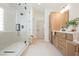 Modern bathroom with a glass shower, light wood cabinets, and bright lighting at 8104 Bay Harbor Dr, Las Vegas, NV 89128
