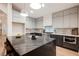 Modern kitchen with stainless steel appliances, grey cabinetry, and a large island with seating at 8104 Bay Harbor Dr, Las Vegas, NV 89128