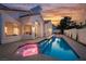 Backyard featuring a beautiful pool, spa and outdoor seating area with a lovely sunset at 8104 Bay Harbor Dr, Las Vegas, NV 89128
