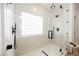 Modern shower featuring white marble tiling, black hardware, and clear glass enclosure at 8104 Bay Harbor Dr, Las Vegas, NV 89128