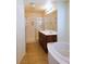 A spacious bathroom features a soaking tub, a glass-enclosed shower, and a vanity with a mirror, offering comfort and style at 8550 Bright Bush St, Las Vegas, NV 89131