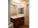 Bright bathroom featuring a wood vanity, white countertop, and a large mirror with vanity lighting at 8550 Bright Bush St, Las Vegas, NV 89131
