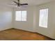 Bedroom featuring neutral paint, brown carpet, two windows, and a ceiling fan at 8550 Bright Bush St, Las Vegas, NV 89131