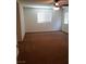 A bright bedroom featuring plush carpet, a ceiling fan, and large windows that provide plenty of natural light at 8550 Bright Bush St, Las Vegas, NV 89131