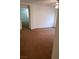 Bright bedroom with neutral paint, ceiling fan, brown carpet, and an open doorway at 8550 Bright Bush St, Las Vegas, NV 89131