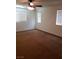 A bright bedroom featuring plush carpet, a ceiling fan, and windows with blinds, creating a comfortable private space at 8550 Bright Bush St, Las Vegas, NV 89131