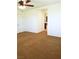 A spacious bedroom showing neutral carpet, a fan and light, and an open view into an adjacent bathroom at 8550 Bright Bush St, Las Vegas, NV 89131