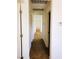Hallway with white walls, brown carpet, and several doorways leading to rooms at 8550 Bright Bush St, Las Vegas, NV 89131