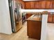 This kitchen features stainless steel appliances, dark cabinets, stone countertops and tile floors at 8550 Bright Bush St, Las Vegas, NV 89131