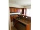 Spacious kitchen with dark wood cabinets, a large island and stainless steel appliances for cooking and storage at 8550 Bright Bush St, Las Vegas, NV 89131