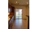 View of a kitchen with granite countertops, and a sliding door leading to the backyard at 8550 Bright Bush St, Las Vegas, NV 89131