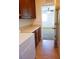 A well-equipped laundry area with washer, dryer, counter space and wooden cabinets providing efficient utility at 8550 Bright Bush St, Las Vegas, NV 89131