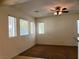 Living room with large windows and a ceiling fan providing ample natural light at 8550 Bright Bush St, Las Vegas, NV 89131
