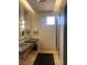 Modern bathroom featuring dual sinks and granite countertops, providing a sleek design at 87 E Agate Ave # 202, Las Vegas, NV 89123
