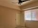 Bright bedroom featuring a window, neutral walls, and an open doorway at 87 E Agate Ave # 202, Las Vegas, NV 89123