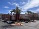 Exterior of community buildings with palm trees and parking, under a blue sky at 87 E Agate Ave # 202, Las Vegas, NV 89123