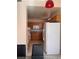 The kitchen features wooden cabinets, a microwave, an oven, and a white refrigerator at 87 E Agate Ave # 202, Las Vegas, NV 89123