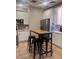 Modern kitchen features white cabinetry, stainless appliances, and a stylish bar table at 87 E Agate Ave # 202, Las Vegas, NV 89123