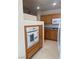 Cozy kitchen with oak cabinets, featuring an oven and appliances at 87 E Agate Ave # 202, Las Vegas, NV 89123