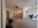 Open-concept living room and dining area with neutral carpet and ceiling fan at 87 E Agate Ave # 202, Las Vegas, NV 89123