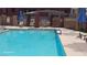 Community pool featuring clear blue water and shaded seating area at 87 E Agate Ave # 202, Las Vegas, NV 89123