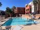 Inviting community pool with lounge chairs and umbrellas, perfect for relaxation and recreation at 87 E Agate Ave # 202, Las Vegas, NV 89123