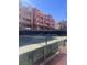 Well-maintained tennis court surrounded by lush landscaping and modern condominium buildings at 87 E Agate Ave # 202, Las Vegas, NV 89123
