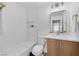 Clean bathroom with modern vanity, tub, and shower combination with decorative tile at 9078 Hilverson Ave, Las Vegas, NV 89148