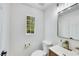 Bathroom features a decorative sink, toilet, and bright natural light from a window at 9078 Hilverson Ave, Las Vegas, NV 89148
