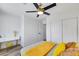 Bright bedroom featuring wood-look flooring, ceiling fan, closet, desk and a stool at 9078 Hilverson Ave, Las Vegas, NV 89148