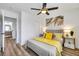 Bedroom with wood-look flooring, ceiling fan, closet, nightstands and a ensuite bathroom at 9078 Hilverson Ave, Las Vegas, NV 89148
